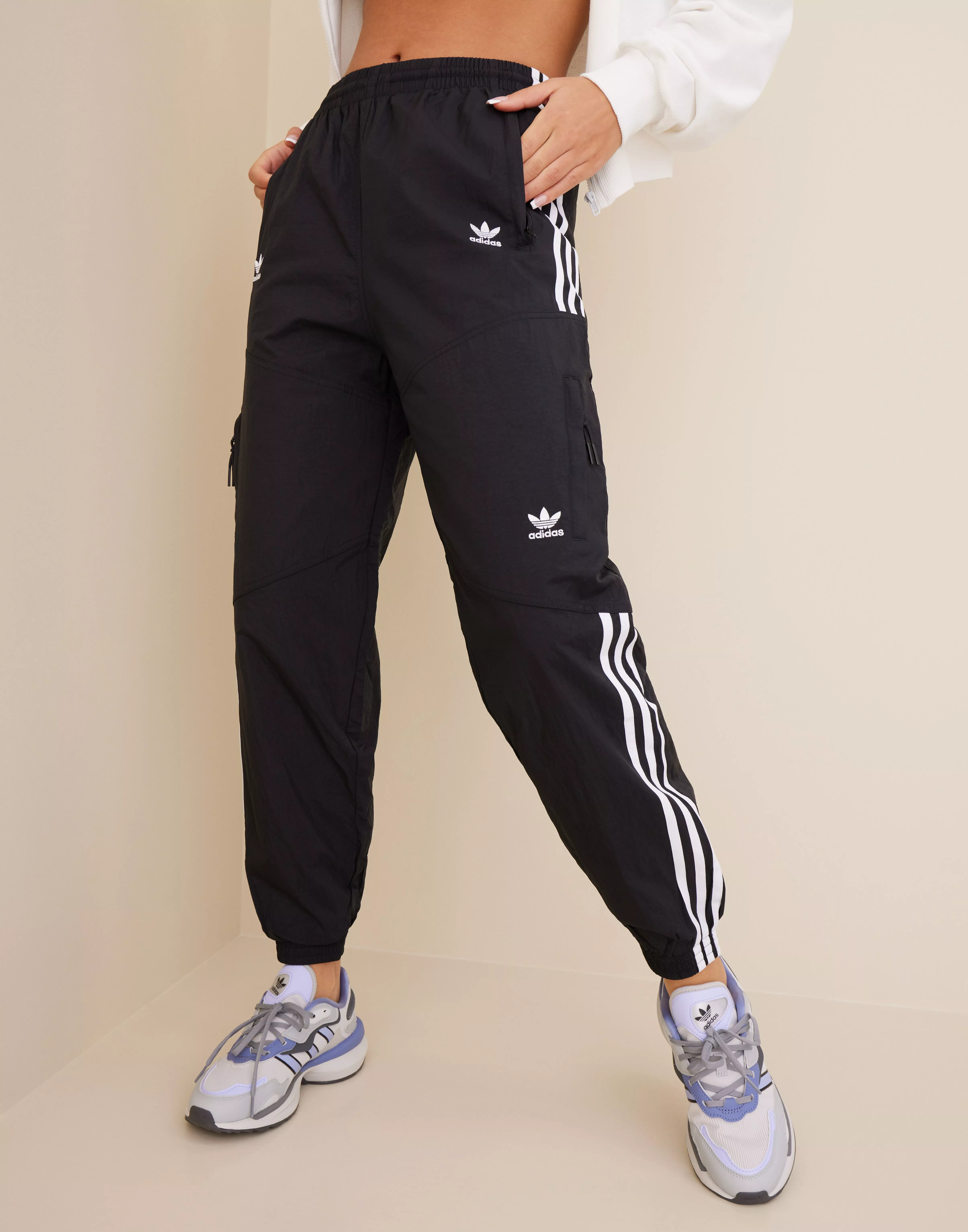 Adidas originals adicolor locked up logo track pants sales in black